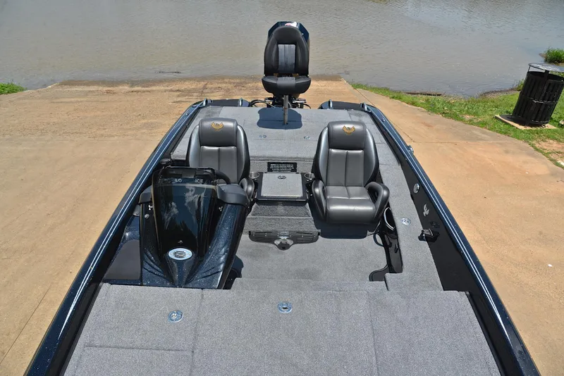 Slide: The Image of 2022 Phoenix 920 Elite boat interior with seating and control panel by the water. - 21