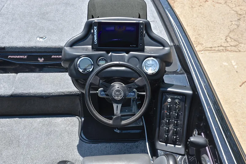 Slide: The Image of 2022 Phoenix 920 Elite boat dashboard with steering wheel and control panel. - 25