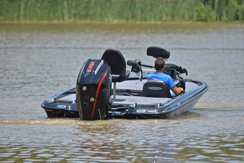 Slide: The Image of 2022 Phoenix 920 Elite boat on water, rear view with outboard motor. - 9