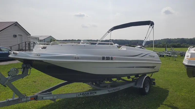 Slide: The Image of 2016 Starcraft Limited 1915 OB boat on trailer, parked on grass. - 1