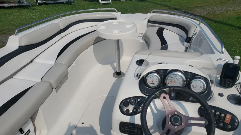 Slide: The Image of 2016 Starcraft Limited 1915 OB boat interior with seating, steering wheel, and control panel. - 4