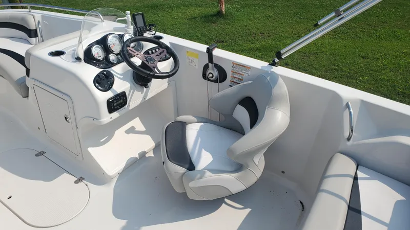 Slide: The Image of 2016 Starcraft Limited 1915 OB boat interior with steering wheel and seating. - 5