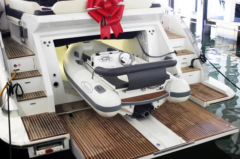 Slide: The Image of Luxury yacht with Aquascan 11 tender, 2015 model, featuring a red bow and wooden deck. - 6