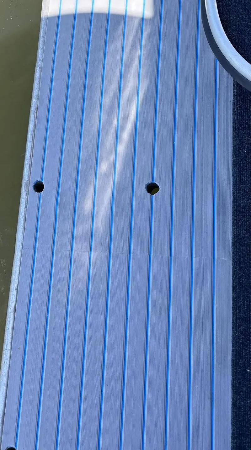 Slide: The Image of Close-up of 1998 Stardust Cruisers 16x77 houseboat deck with blue-striped pattern. - 15