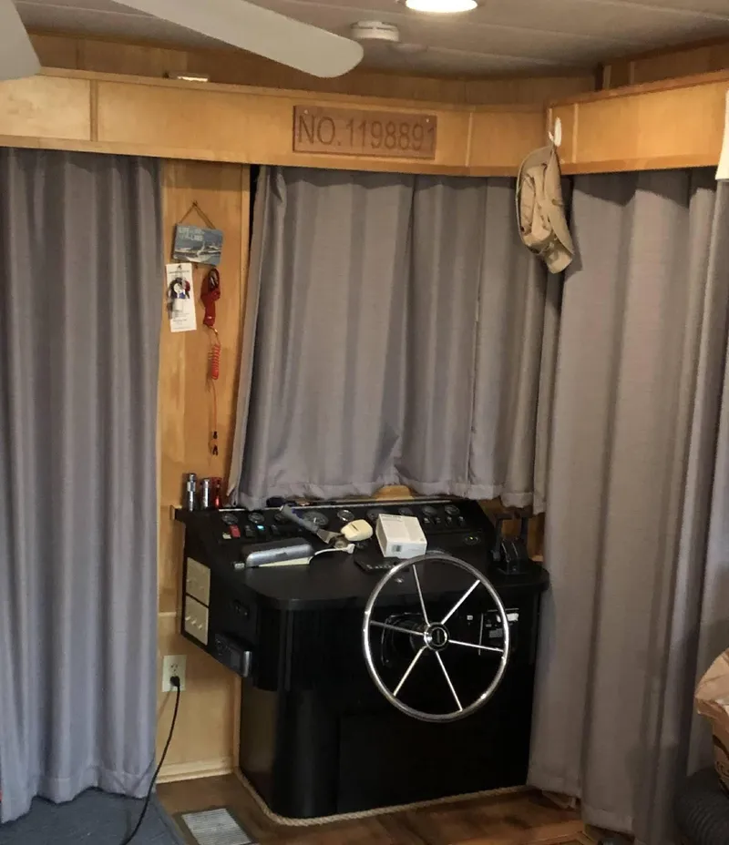 Slide: The Image of 1998 Stardust Cruisers 16x77 houseboat helm with steering wheel and control panel. - 3