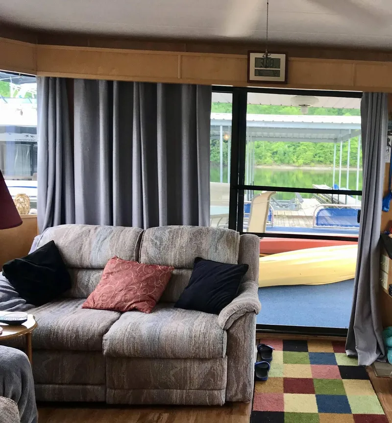 Slide: The Image of Interior of a 1998 Stardust Cruisers 16x77 houseboat with cozy seating and colorful decor. - 6