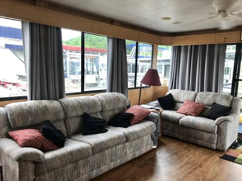 Slide: The Image of 1998 Stardust Cruisers 16x77 houseboat interior with cozy sofas and large windows. - 7