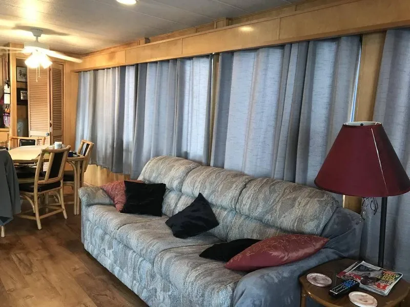 Slide: The Image of Cozy interior of 1998 Stardust Cruisers 16x77 houseboat with sofa and dining area. - 8