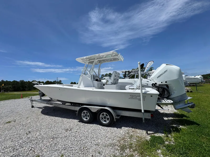 Slide: The Image of 2021 ZCB 26 Freemason boat on trailer, parked outdoors under clear blue sky. - 13