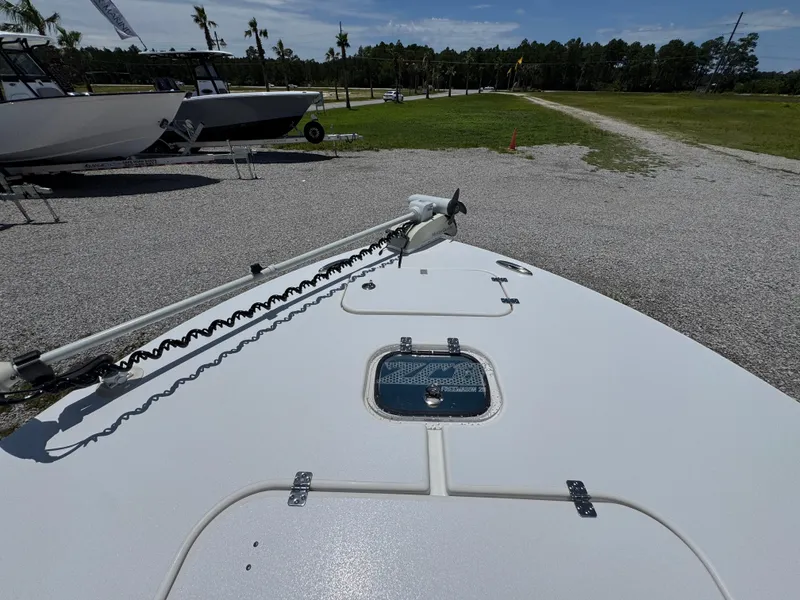 Slide: The Image of 2021 ZCB 26 Freemason boat deck with hatch and trolling motor in a gravel lot. - 16