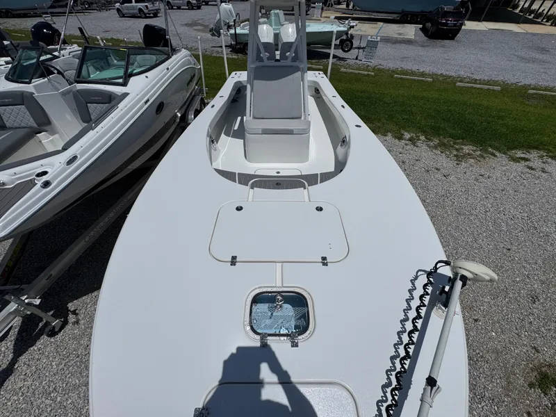 Slide: The Image of 2021 ZCB 26 Freemason boat, top view, docked beside another boat on gravel. - 18