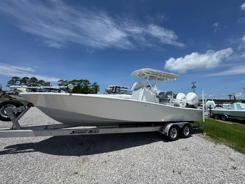 Slide: The Image of 2021 ZCB 26 Freemason boat on trailer under clear blue sky. - 2