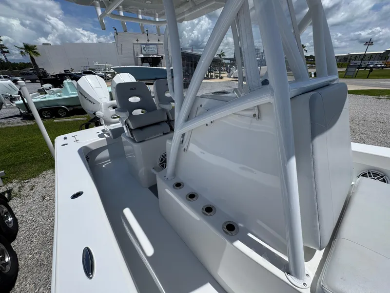 Slide: The Image of 2021 ZCB 26 Freemason boat with seating and rod holders, displayed outdoors. - 22