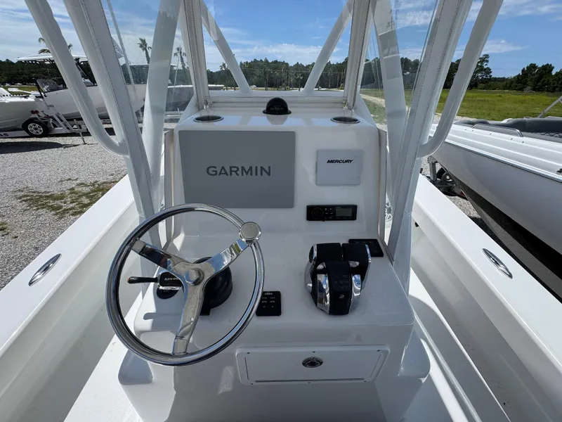 Slide: The Image of 2021 ZCB 26 Freemason boat console with Garmin and Mercury controls. - 26