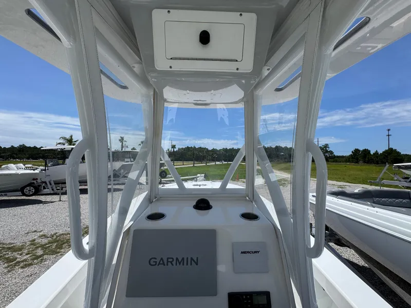 Slide: The Image of 2021 ZCB 26 Freemason boat cockpit with Garmin navigation system, clear skies in the background. - 27