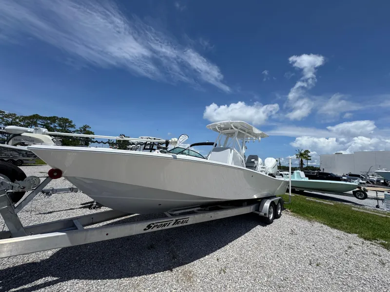 Slide: The Image of 2021 ZCB 26 Freemason boat on trailer under clear blue sky. - 3