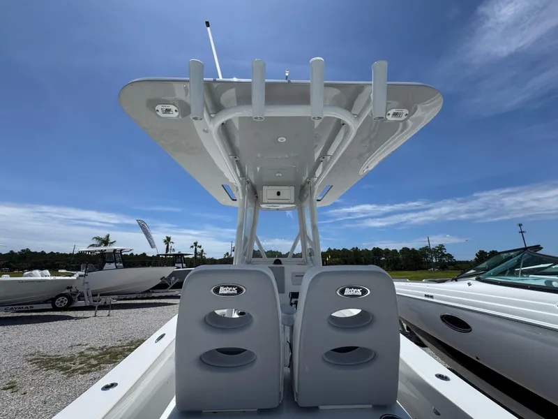 Slide: The Image of 2021 ZCB 26 Freemason boat with dual seats and T-top under clear blue sky. - 30