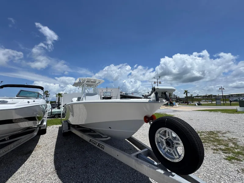 Slide: The Image of 2021 ZCB 26 Freemason boat on trailer under blue sky. - 7