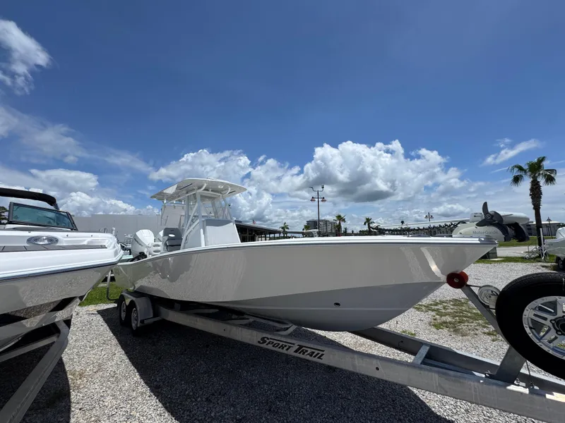 Slide: The Image of 2021 ZCB 26 Freemason boat on trailer under blue sky. - 8