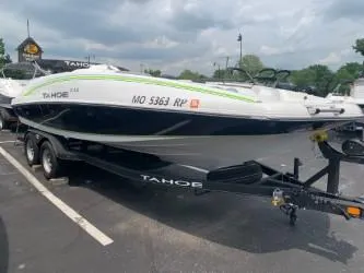 The Image of 2023 Tahoe 2150 boat on trailer in parking lot, cloudy sky background. - 1