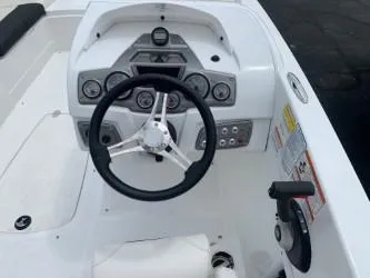 Slide: The Image of 2023 Tahoe 2150 boat dashboard with steering wheel and control panel. - 3