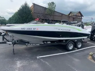 Slide: The Image of 2023 Tahoe 2150 boat on trailer in parking lot, overcast sky. - 6