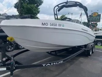 The Image of 2024 Tahoe T21 boat on trailer, parked outdoors, showcasing sleek design and modern features. - 0
