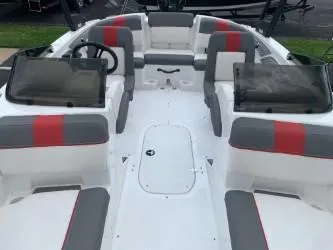 Slide: The Image of 2024 Tahoe T21 boat interior with gray and red seating, steering wheel, and windshield. - 3