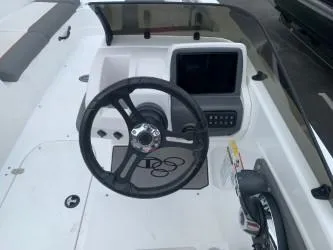 Slide: The Image of 2024 Tahoe T21 boat dashboard with steering wheel and control panel. - 5