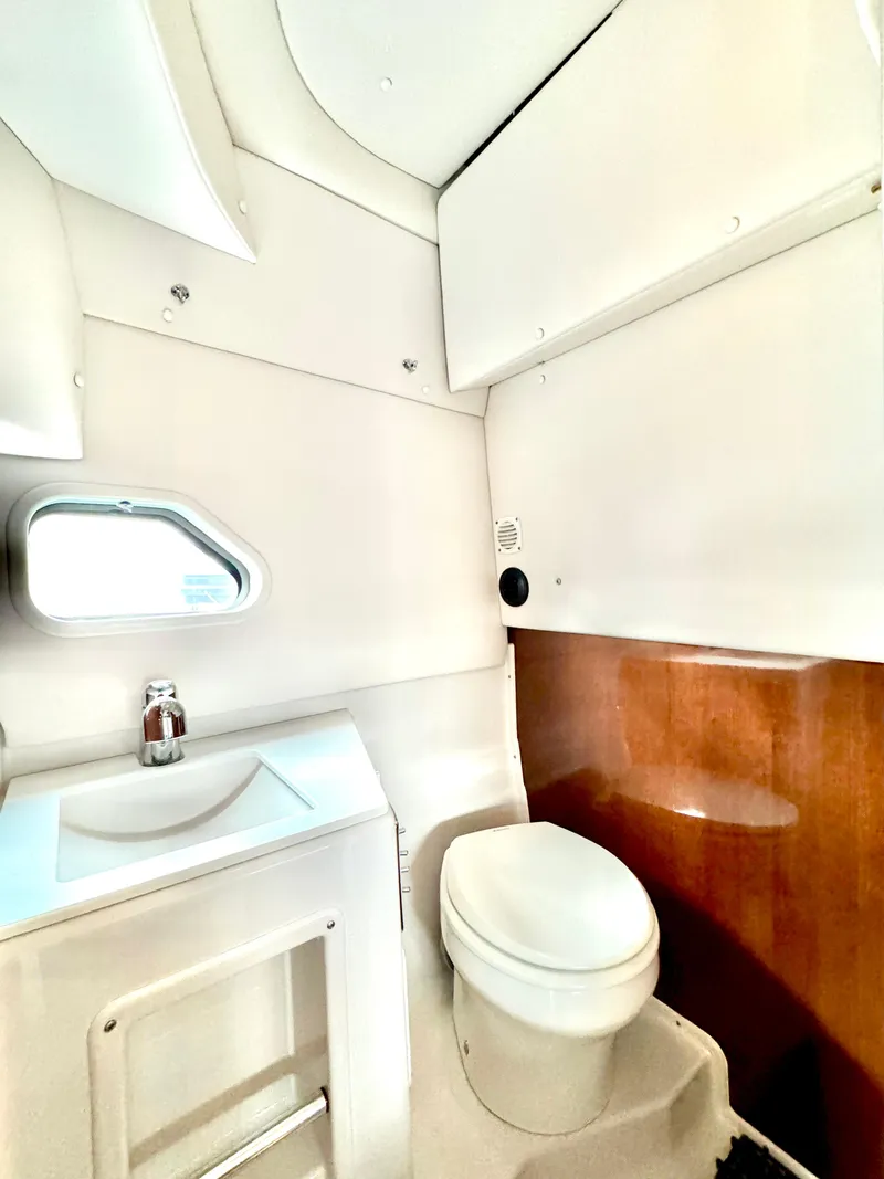 Slide: The Image of 2016 Four Winns 255 Vista boat bathroom with sink and toilet. - 3