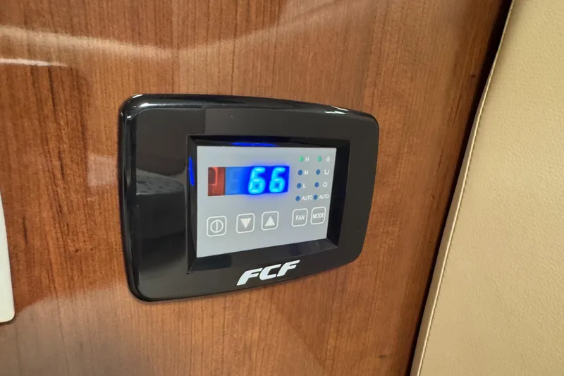Slide: The Image of Digital control panel on 2016 Four Winns 255 Vista boat, displaying temperature. - 7