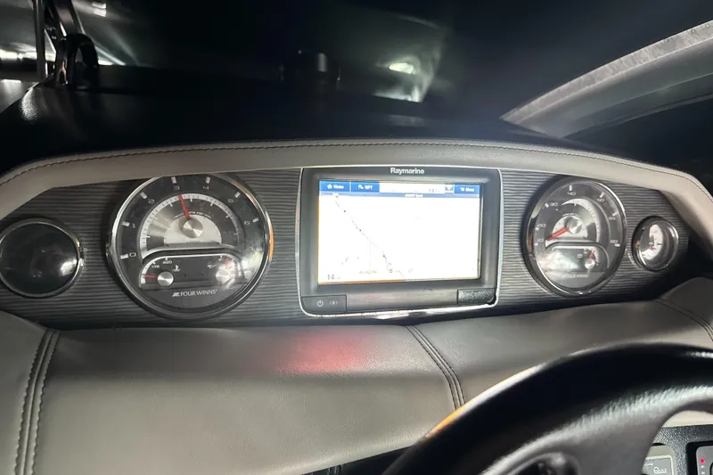 Slide: The Image of Dashboard of 2016 Four Winns 255 Vista boat with navigation display and gauges. - 8