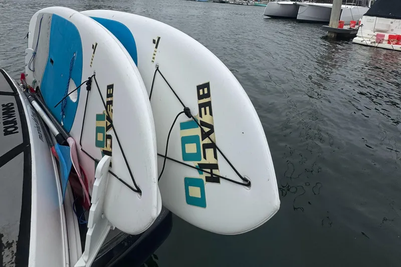 Slide: The Image of Two paddleboards on a 2016 Four Winns 255 Vista boat docked at a marina. - 9