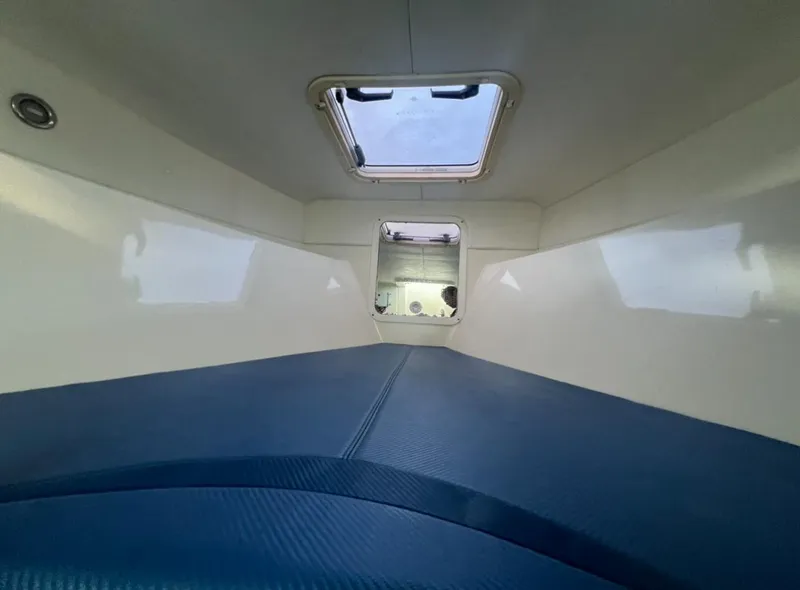 Slide: The Image of Interior cabin of 2011 Spectre 360 Roadster with blue seating and overhead window. - 10