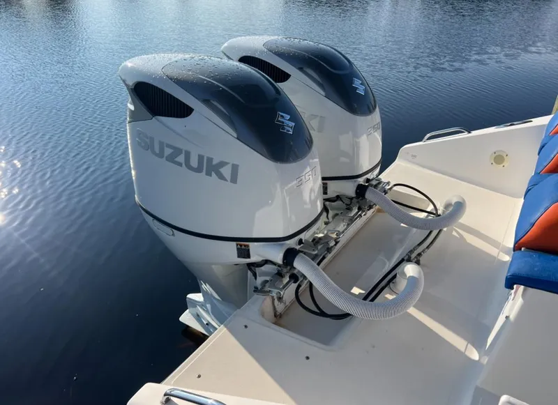 Slide: The Image of Twin Suzuki outboard motors on a Spectre 360 Roadster, 2011 model, in calm waters. - 16