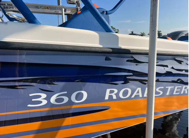 Slide: The Image of 2011 Spectre 360 Roadster boat with blue and orange design. - 19