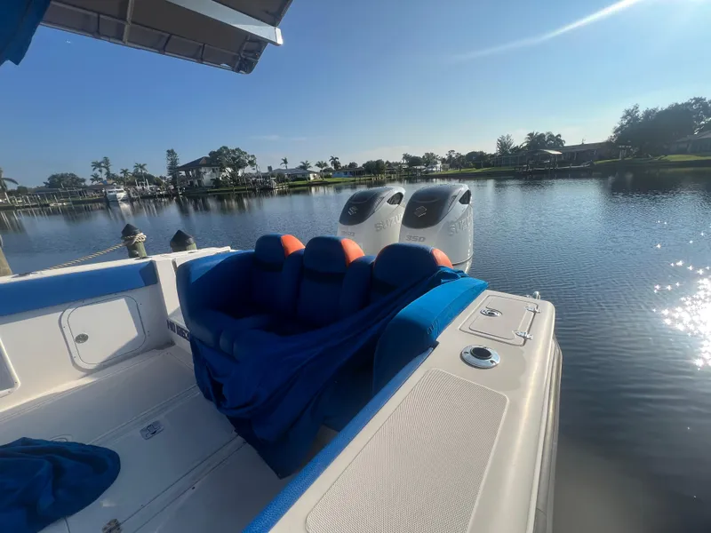 Slide: The Image of Spectre 360 Roadster 2011 boat on a serene lake with dual engines. - 22