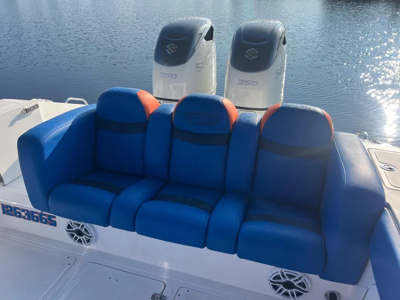 Slide: The Image of Blue and orange seating on 2011 Spectre 360 Roadster boat with twin 350 engines. - 24
