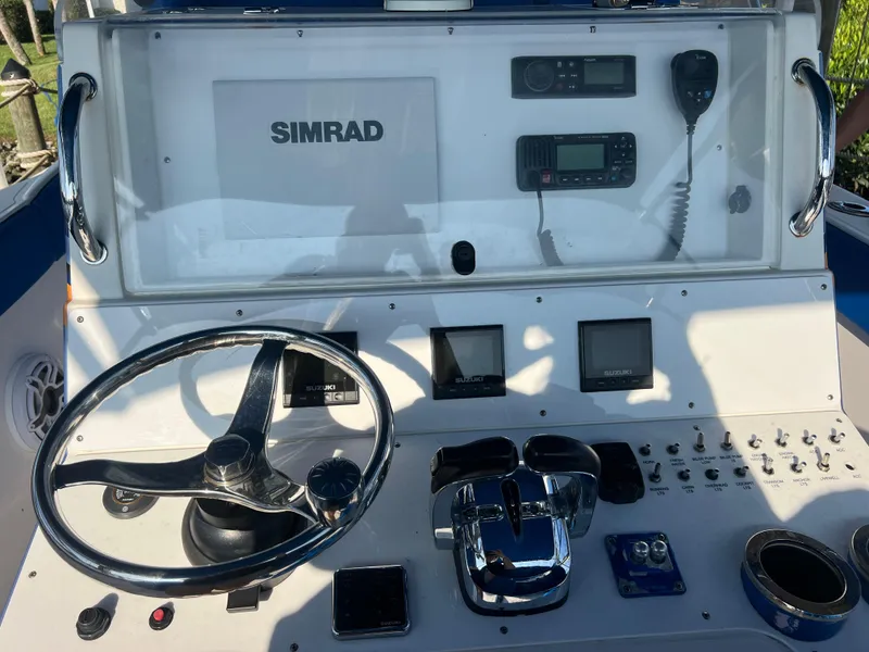 Slide: The Image of 2011 Spectre 360 Roadster boat dashboard with steering wheel and navigation controls. - 25