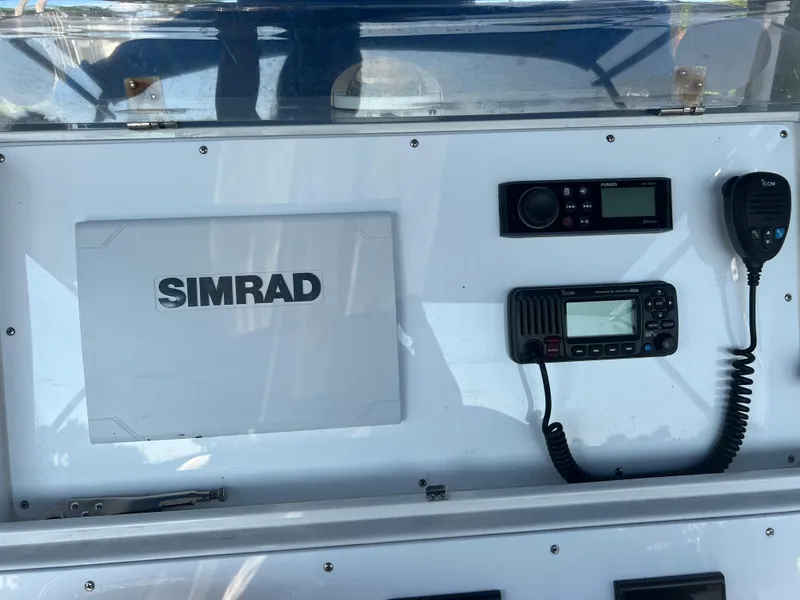 Slide: The Image of Control panel of a 2011 Spectre 360 Roadster with Simrad electronics and communication devices. - 26