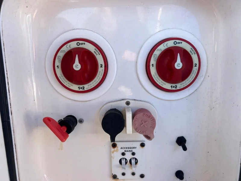 Slide: The Image of Control panel with red switches and accessory ports on a 2011 Spectre 360 Roadster. - 29