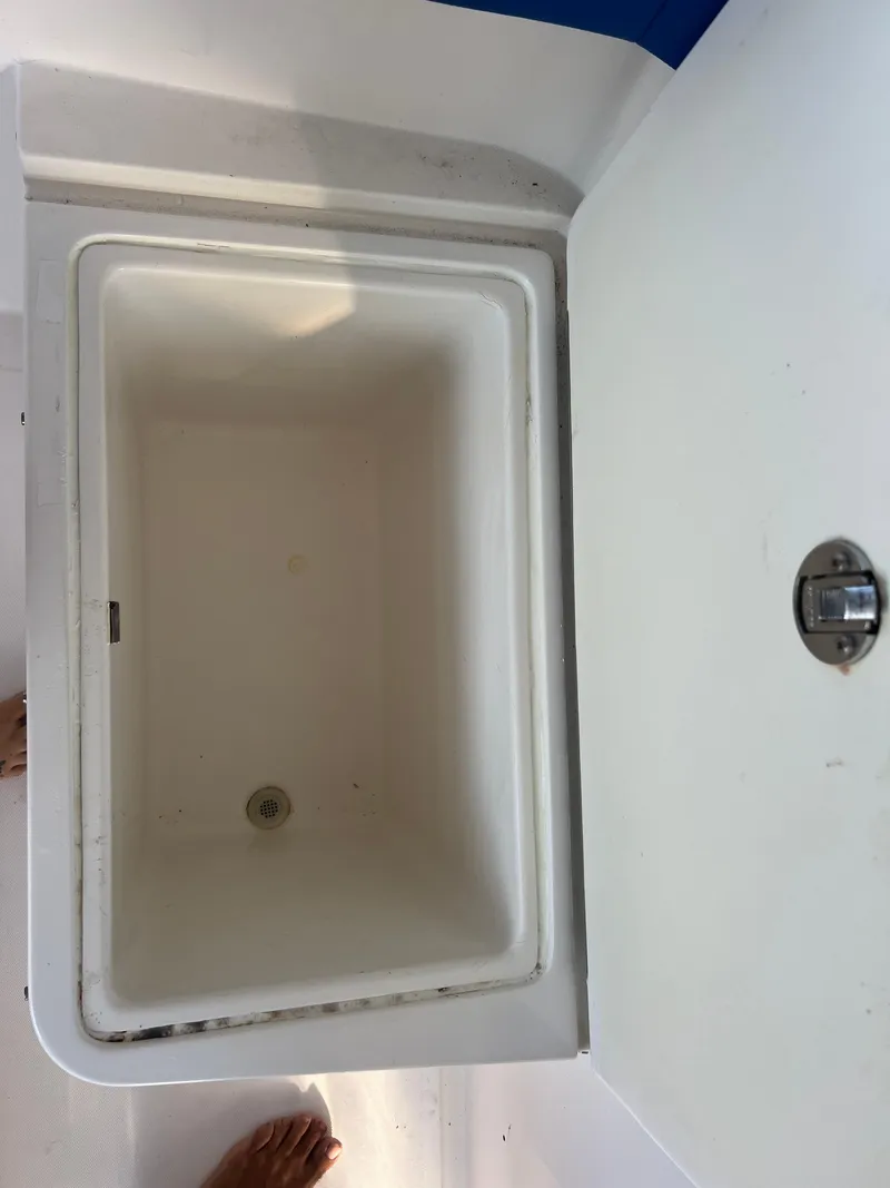 Slide: The Image of Open storage compartment in a 2011 Spectre 360 Roadster boat. - 31