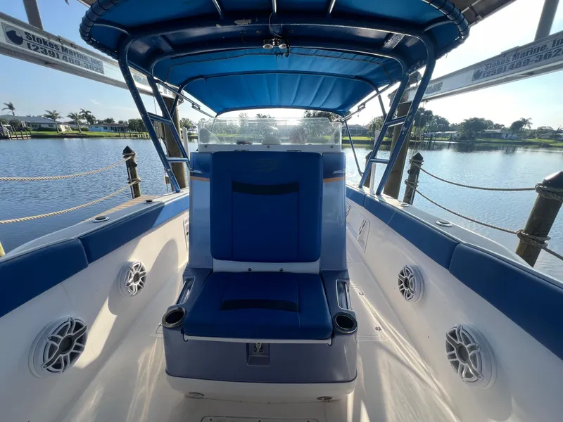 Slide: The Image of Spectre 360 Roadster 2011 boat interior with blue seating and canopy on a sunny day. - 35