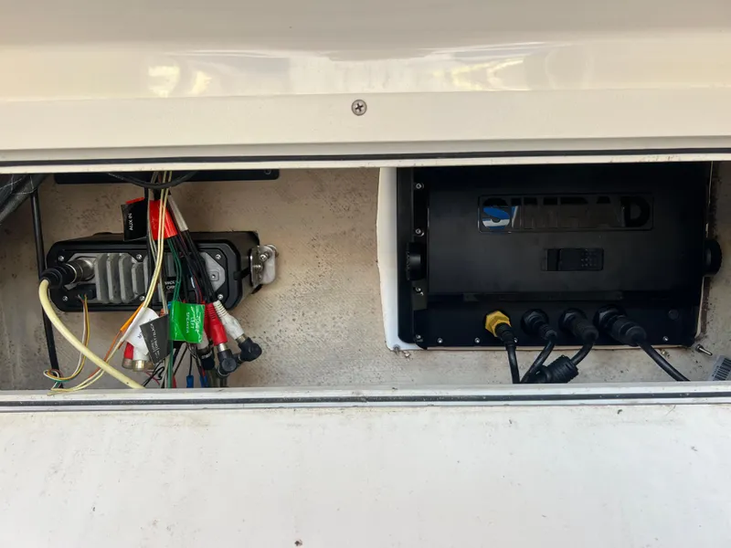 Slide: The Image of Electrical components and wiring inside a 2011 Spectre 360 Roadster compartment. - 36