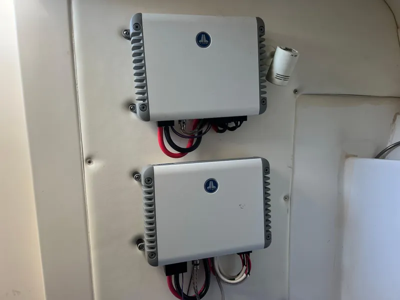 Slide: The Image of Two electrical components mounted on a wall inside a 2011 Spectre 360 Roadster. - 37