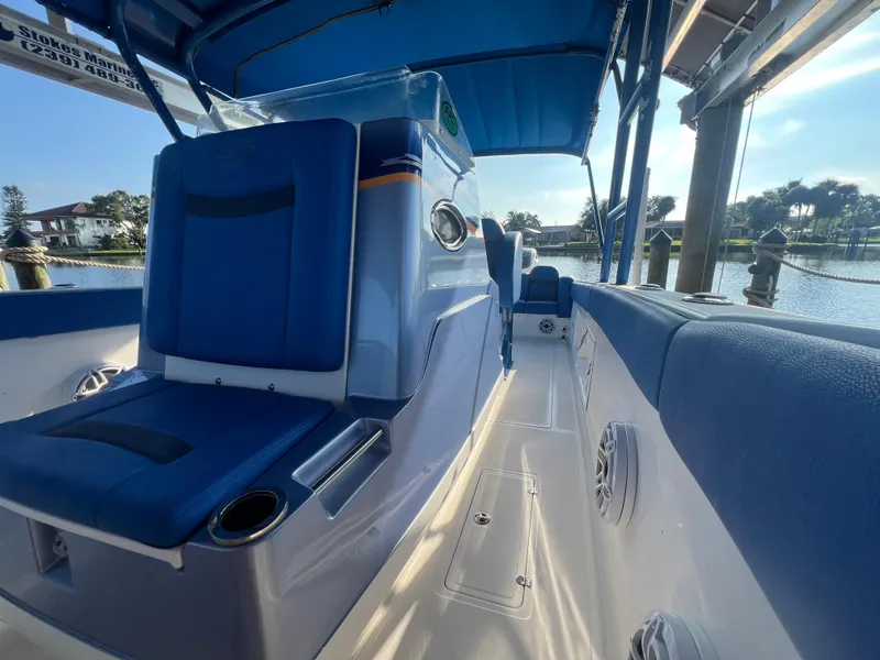Slide: The Image of 2011 Spectre 360 Roadster boat interior with blue seating and waterfront view. - 38