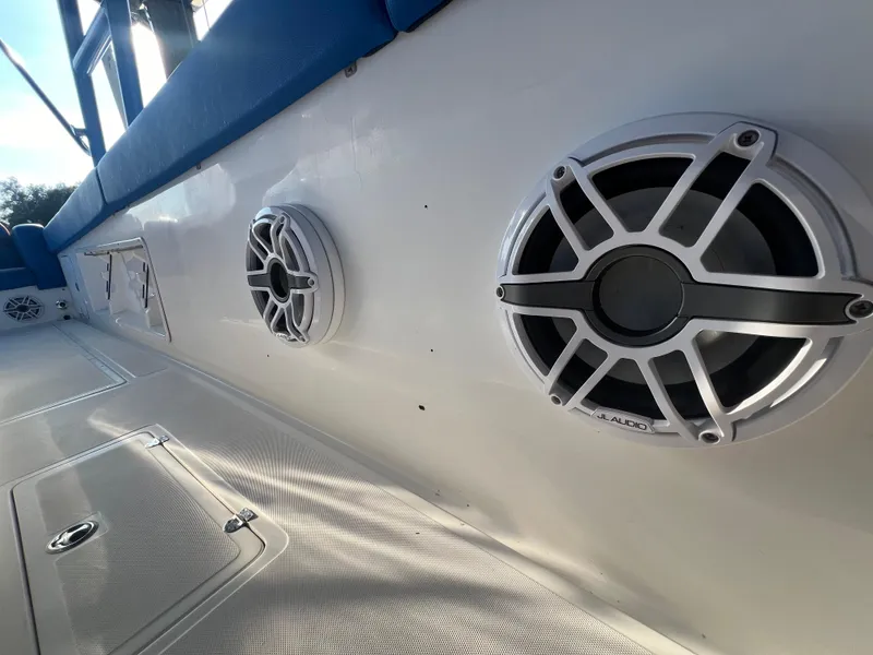 Slide: The Image of Speakers on a 2011 Spectre 360 Roadster boat deck, featuring a sleek white design. - 40