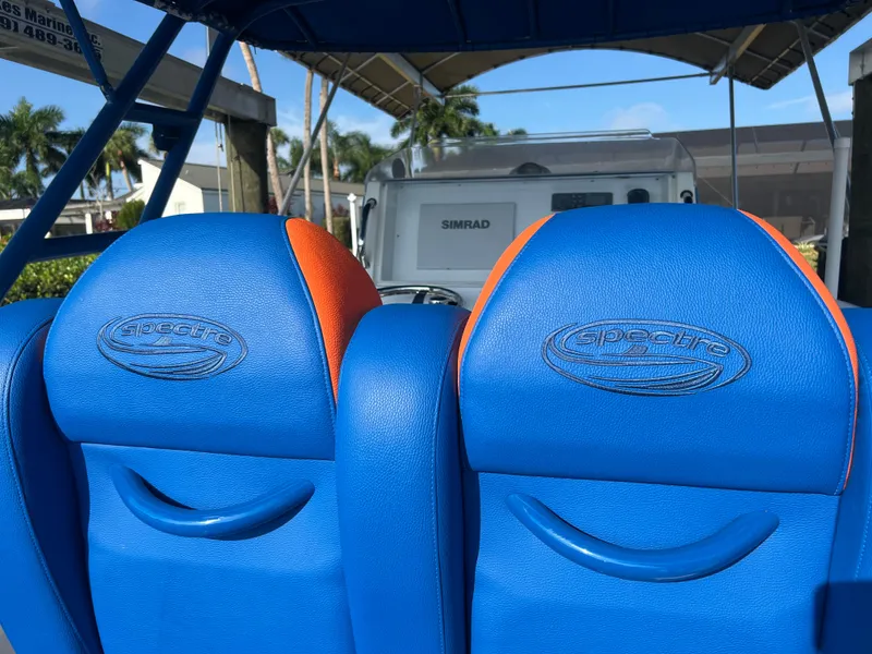 Slide: The Image of Blue and orange seats in a 2011 Spectre 360 Roadster boat. - 45