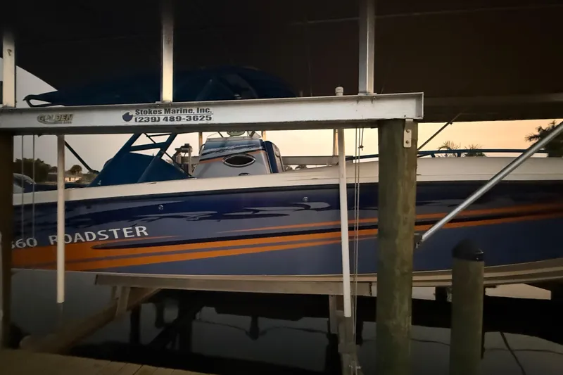 Slide: The Image of Spectre 360 Roadster 2011 boat docked at marina with sunset backdrop. - 62
