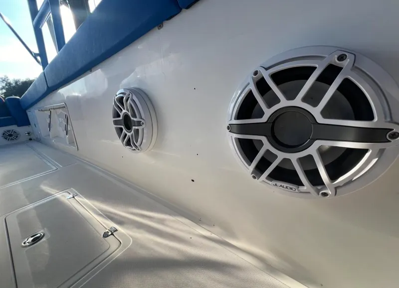 Slide: The Image of Speakers on a 2011 Spectre 360 Roadster boat, featuring a sleek white and blue design. - 9